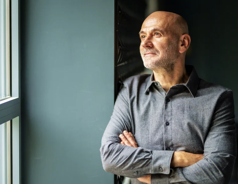 Male looking out window